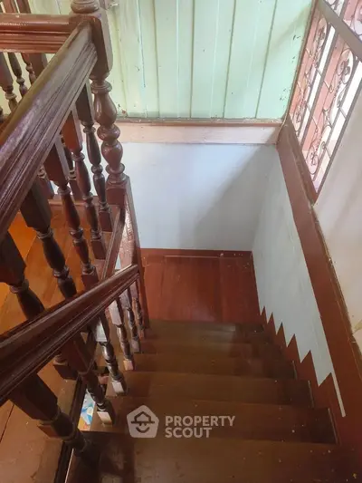 Charming wooden staircase with classic railing in a cozy home interior