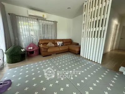 Spacious living room with modern decor and cozy seating area, perfect for family gatherings.