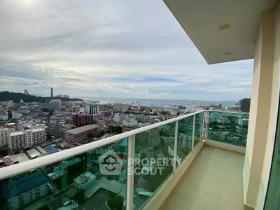 Stunning high-rise balcony with panoramic city and ocean views.