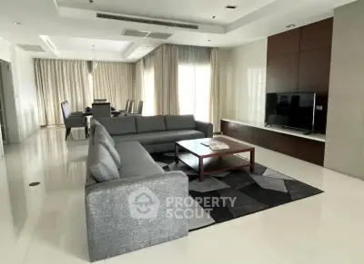 Spacious modern living room with elegant decor and large windows