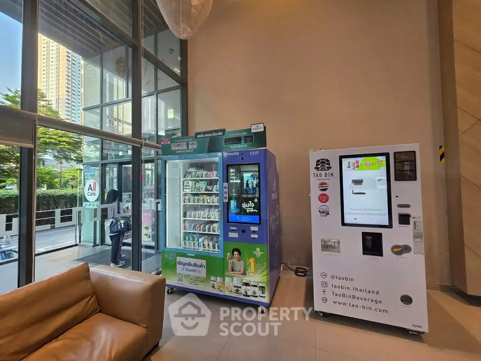 Modern building entrance with vending machines and glass facade