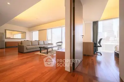 Spacious modern living room with hardwood floors and natural light