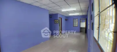 Spacious interior with vibrant blue walls and tiled flooring, ideal for creative customization.