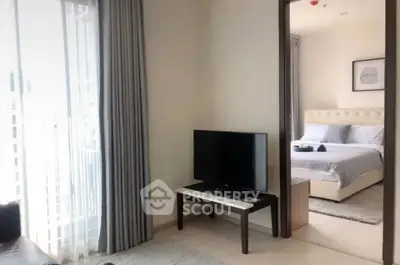 Modern apartment interior with cozy living room and elegant bedroom view.