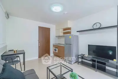 Modern living room with sleek furniture and integrated kitchen appliances in a cozy apartment.