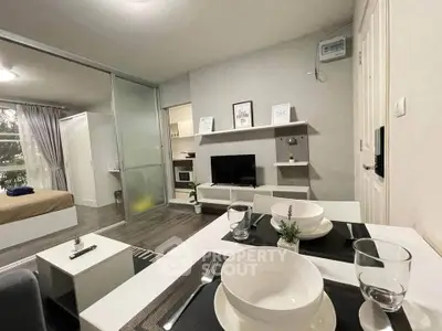 Modern open-plan living room with dining area and bedroom in stylish apartment