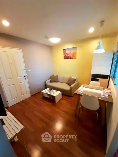 Cozy living room with modern decor and wooden flooring in a stylish apartment.