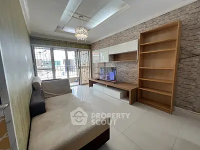 Modern living room with stylish decor and large windows offering ample natural light.