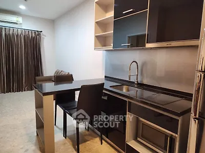 Modern kitchen with sleek black cabinetry and open layout in stylish apartment
