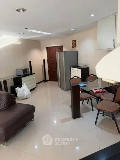 Spacious living room with modern furniture and appliances in a cozy apartment.