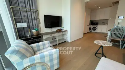 Modern living room with stylish furniture and open kitchen layout in a contemporary apartment.