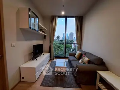 Modern living room with stylish furniture and city view from large window.