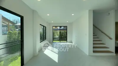 Spacious modern living room with large windows and garden view