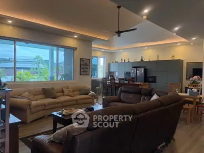 Spacious living room with modern decor and large windows offering natural light.
