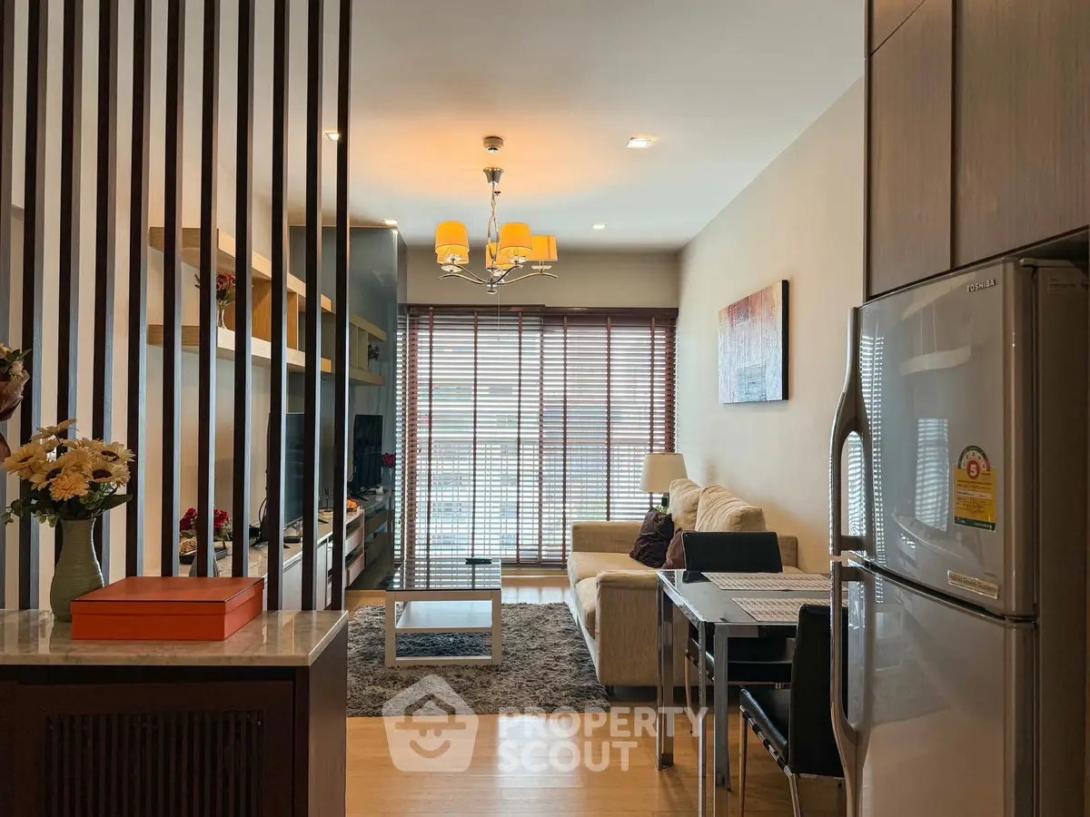 Modern living room with open layout, cozy seating, and stylish decor in a contemporary apartment.