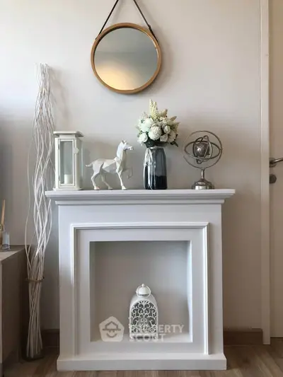 Stylish living room corner with decorative fireplace, mirror, and elegant decor accents.