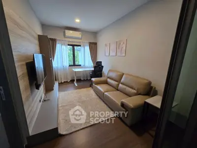 Modern living room with sleek furniture and natural light, perfect for relaxation and entertainment.