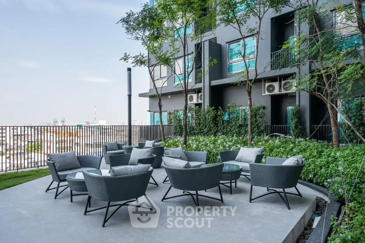 Modern outdoor seating area with city view in luxury apartment complex