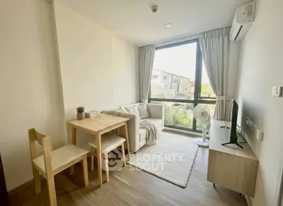 Bright and cozy living room with large window and modern furnishings