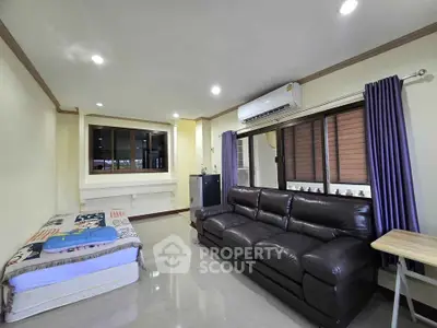 Spacious living room with modern sofa and air conditioning
