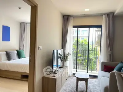 Modern living room with balcony view and adjacent bedroom in stylish apartment.