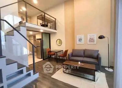 Modern loft apartment with stylish living room and open kitchen layout.