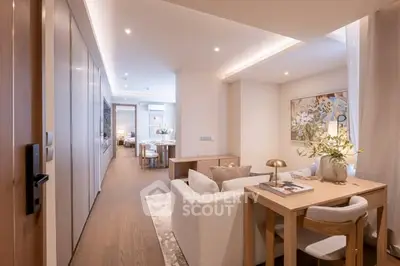 Luxurious open-plan living room with elegant decor and modern lighting in a stylish apartment.