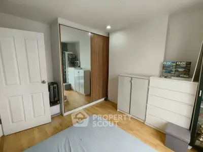 Spacious bedroom with modern wardrobe and wooden flooring