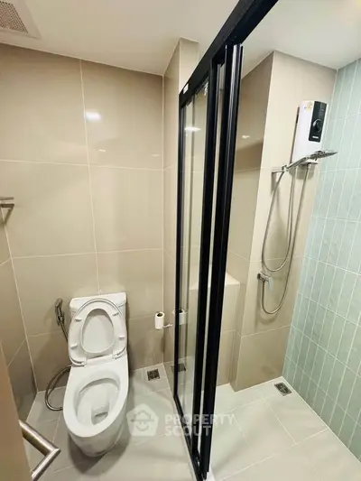 Modern bathroom with glass shower door and sleek fixtures