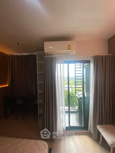 Cozy bedroom with balcony view and air conditioning in modern apartment