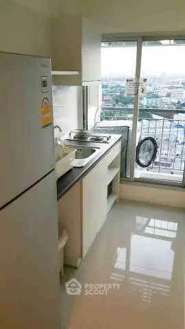 Modern kitchen with city view, featuring sleek appliances and ample natural light.
