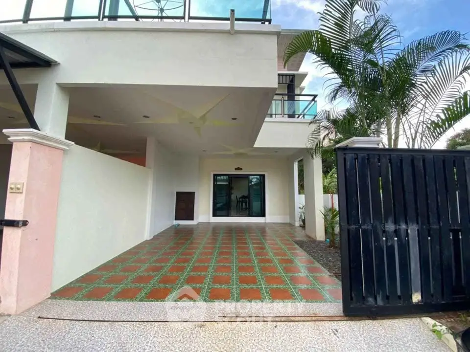 Spacious modern home with tiled driveway and lush greenery, perfect for family living.