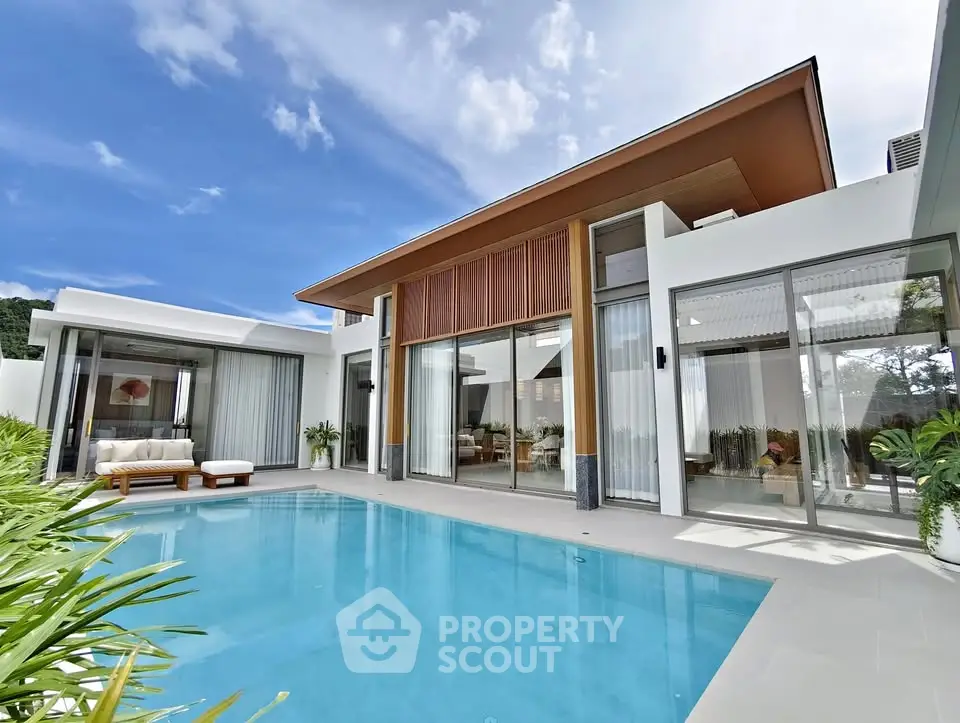 Luxurious modern villa with private pool and elegant outdoor seating area.