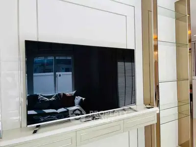 Modern living room with sleek TV and stylish shelving unit