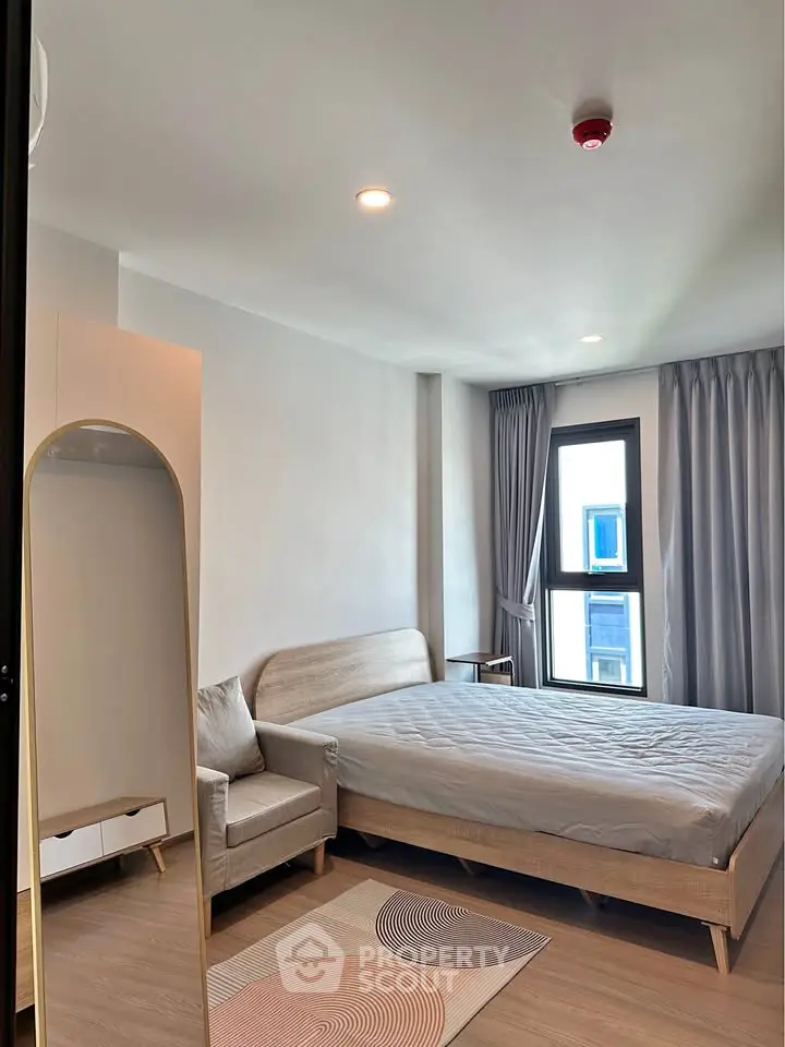 Modern bedroom with stylish decor and natural light