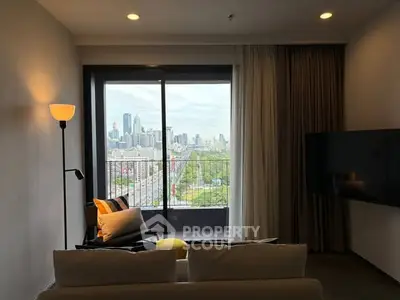 Modern living room with city view from balcony, featuring cozy seating and stylish decor.