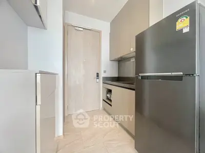 Modern kitchen with sleek appliances and minimalist design in a contemporary apartment.