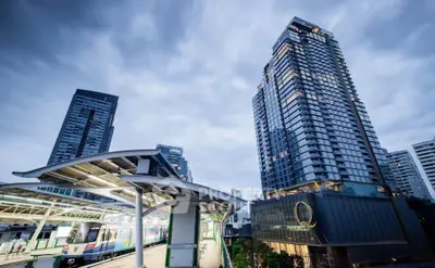 Stunning urban skyline with modern high-rise buildings and a bustling train station.