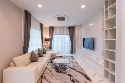 Luxurious living room with modern decor, plush sofa, and stylish marble accents.