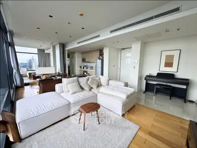 Luxurious open-plan living room with stunning city views and modern furnishings.
