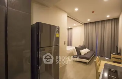 Modern studio apartment with sleek kitchen and cozy living area