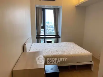 Modern bedroom with large window offering city view, featuring a comfortable bed and minimalist decor.