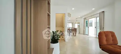 Spacious open-plan living area with modern decor and natural light