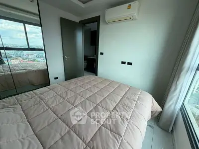 Modern bedroom with city view and mirrored closet doors