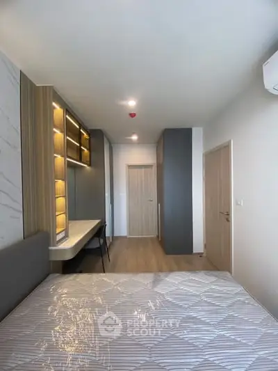 Modern bedroom with stylish built-in shelves and cozy lighting