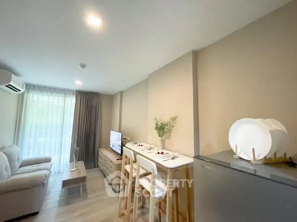 Modern living room with cozy seating and dining area, featuring natural light and stylish decor.