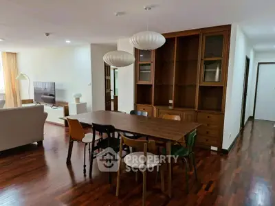 Spacious living and dining area with modern furniture and wooden flooring