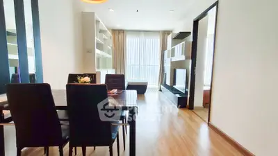 Spacious modern living room with dining area and large windows for natural light.