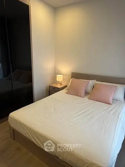 Cozy bedroom with modern design and soft lighting, featuring a comfortable bed and stylish decor.