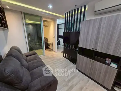 Modern living room with sleek furniture and ambient lighting in a stylish apartment.